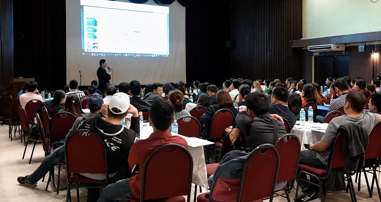 Maj Custodio presenting the AACIO system to a packed hall